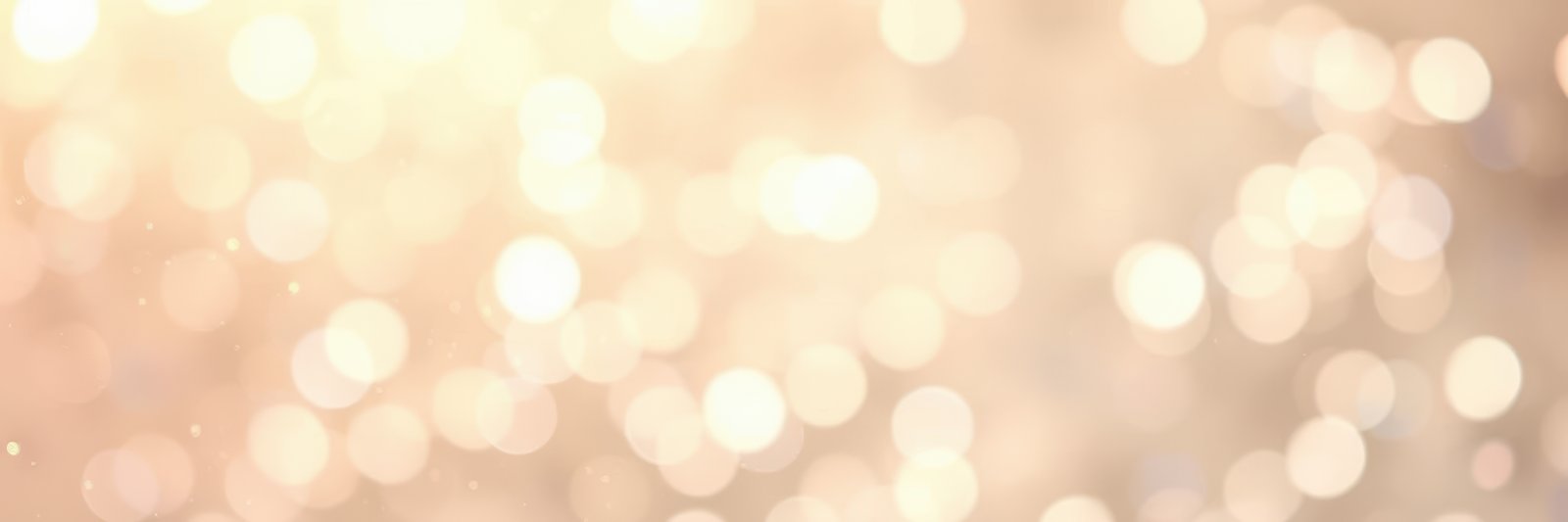 Shimmering golden bokeh effect creating an enchanting atmosphere at a festive gathering during evening hours